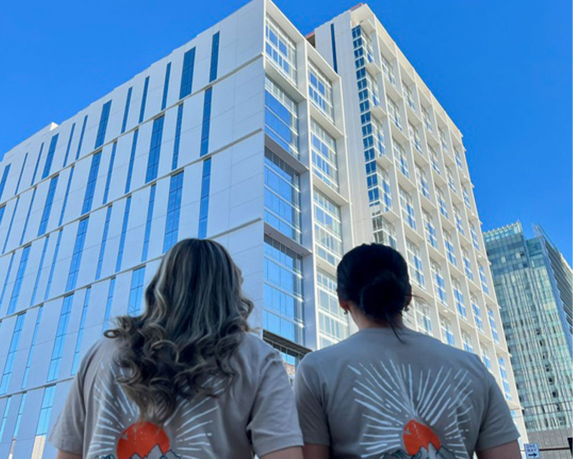 two people looking up at a building